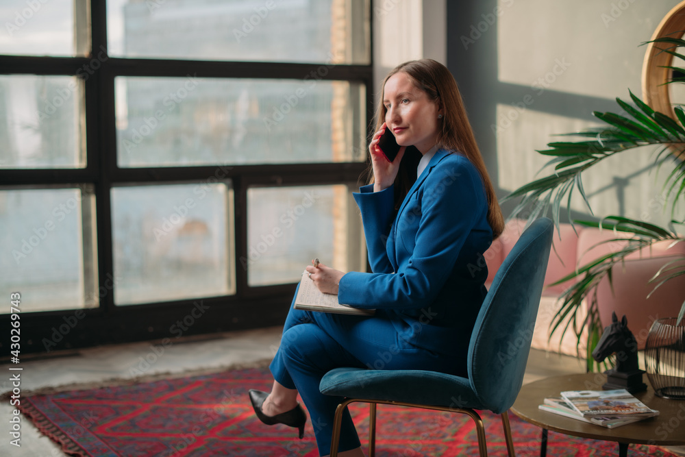 Business woman portrait in modern office interior, talking on the phone. Woman in business, portrait of a businesswoman. Business woman portrait in modern office interior, talking on the phone. Woman in business, portrait of a businesswoman.