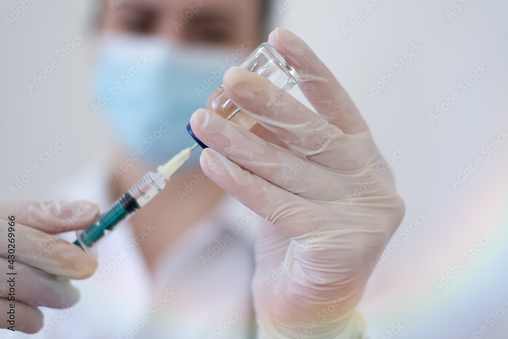 Female Doctor preparing the coronavirus COVID-19 vaccine Female Doctor preparing the coronavirus COVID-19 vaccine