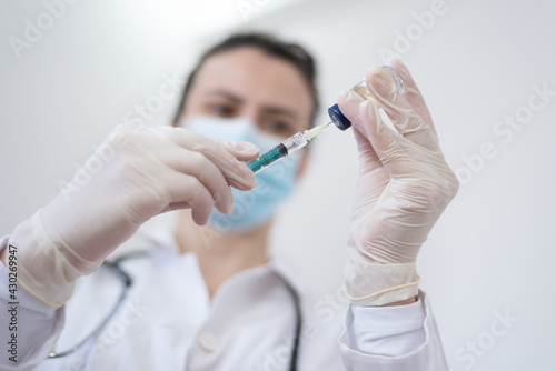Female Doctor preparing the coronavirus COVID-19 vaccine
