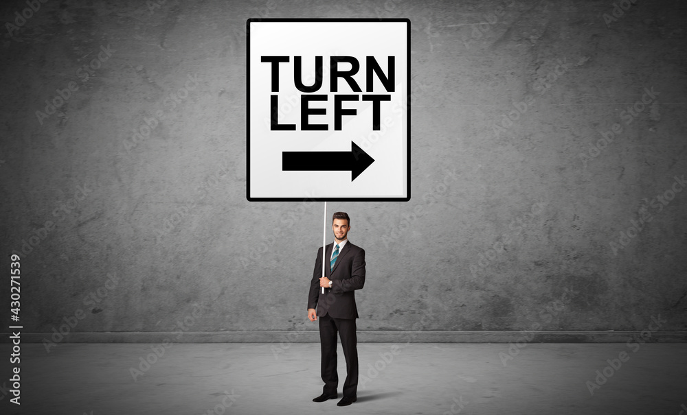 business person holding a traffic sign business person holding a traffic sign