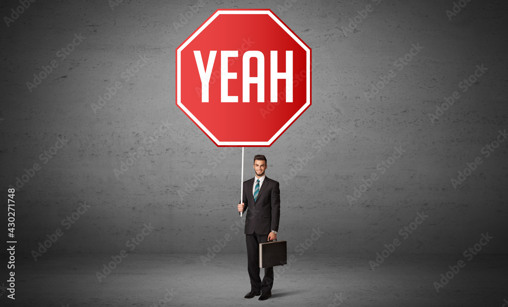 Young business person holding road sign