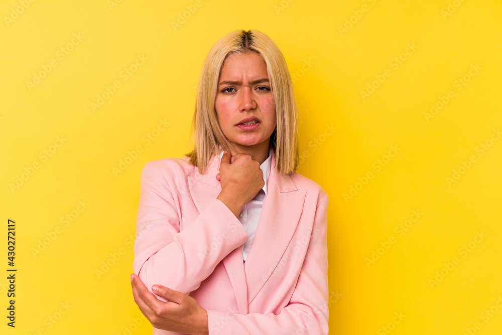 Young venezuelan woman isolated on yellow background massaging elbow, suffering after a bad movement. Young venezuelan woman isolated on yellow background massaging elbow, suffering after a bad movement.