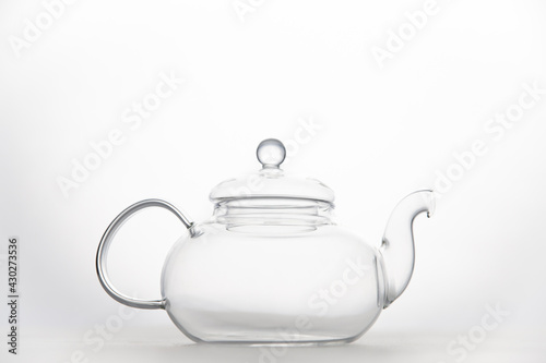 Transparent empty glass teapot isolated on white background