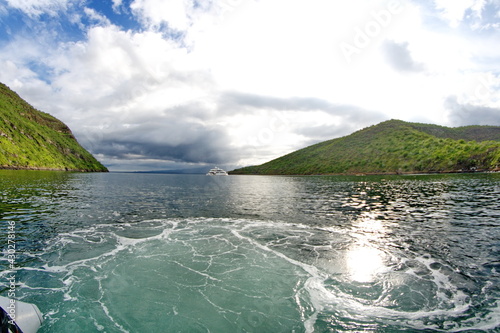 Galapagos cruise ship moored at the mouth of Tagus Cove, Isabela Island, Galapagos, Ecuador, enclosed by mountains photo