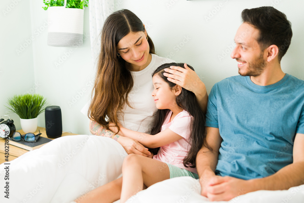 Adorable girl giving love to her parents Adorable girl giving love to her parents