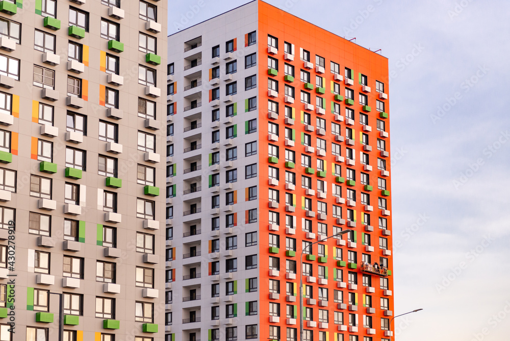 Residential multi-storey towers. Red and Gray house. New homes in new Moscow.