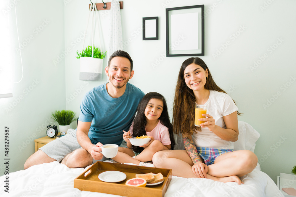 Hispanic parents and daughter eating breakfast Hispanic parents and daughter eating breakfast
