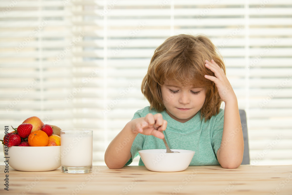 Child eating healthy food at home. Baby eat soup with spoon. Child eating healthy food at home. Baby eat soup with spoon.