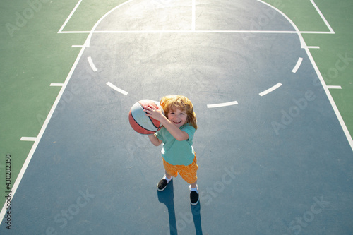 Child sport activity. Boy playing basketball. Kid sportsman. © Volodymyr