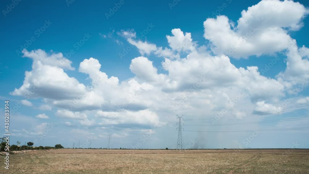 Cloud formation time lapse at the onset of monsoon season over harvested dry rice paddy with smoke coming from crop burning for pest control in the background. Cloud formation time lapse at the onset of monsoon season over harvested dry rice paddy with smoke coming from crop burning for pest control in the background.