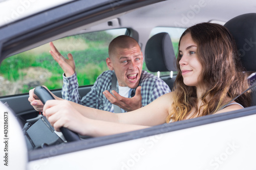 Man and woman are quarreling in the car. Woman driving © JackF