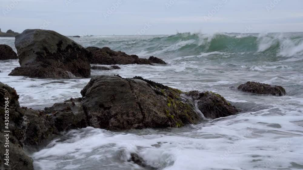 Waves crashing on rocks at dusk Waves crashing on rocks at dusk