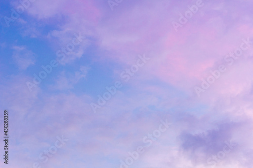 Sunset sky with floating clouds .beautiful cloud illuminated by the sun .concept background sky replacement .blue pink orange colors.