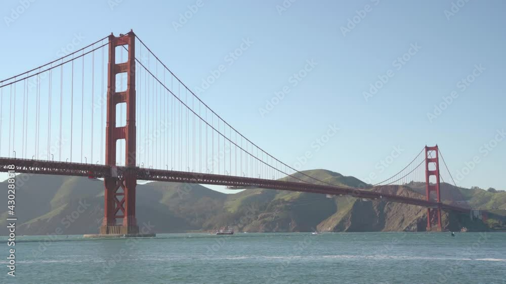 Ships crossing by and people kayaking by the Golden Gate Bridge Ships crossing by and people kayaking by the Golden Gate Bridge