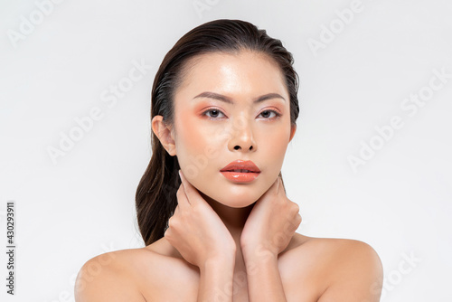 Beauty shot of glamorous Asian woman with makeup on her face isolated on white background for cosmetic and skin care concept