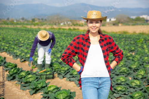 Portrait of successful female farmer on the field
