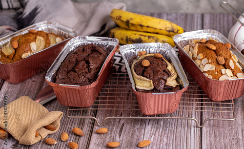 Homemade chocolate banana bread topping with almonds on foil cup.
