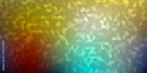Light blue, yellow vector backdrop with a batch of hexagons.