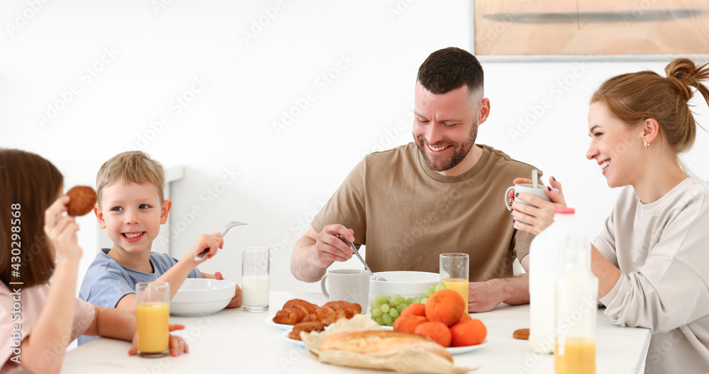 Young happy family having healthy breakfast in morning at home Young happy family having healthy breakfast in morning at home