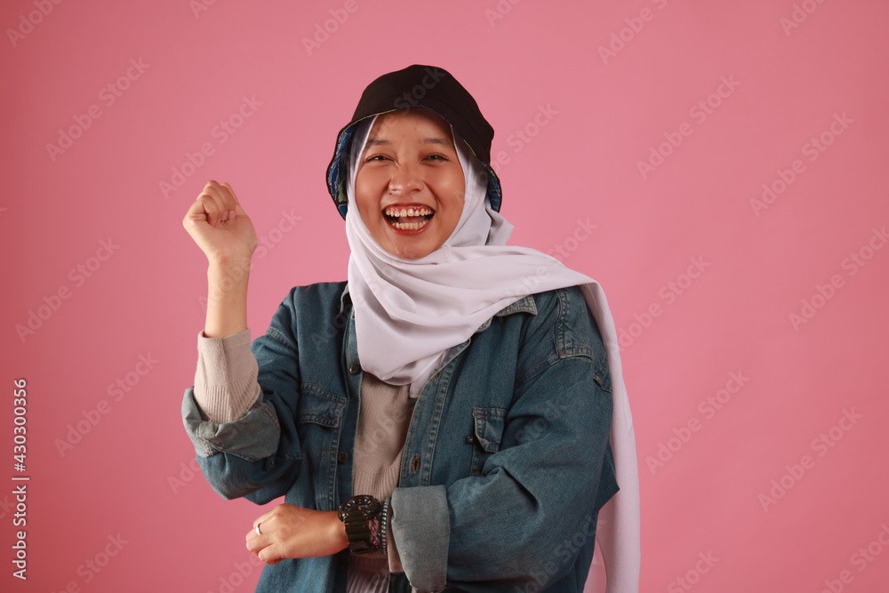 Fashion portrait of young beautiful asian muslim woman with wearing hijab isolated on pink background Fashion portrait of young beautiful asian muslim woman with wearing hijab isolated on pink background