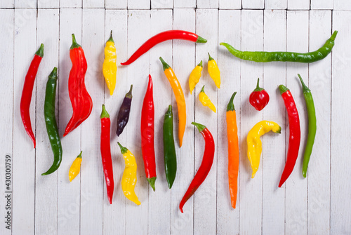 chili pepper selection on white wood table background photo