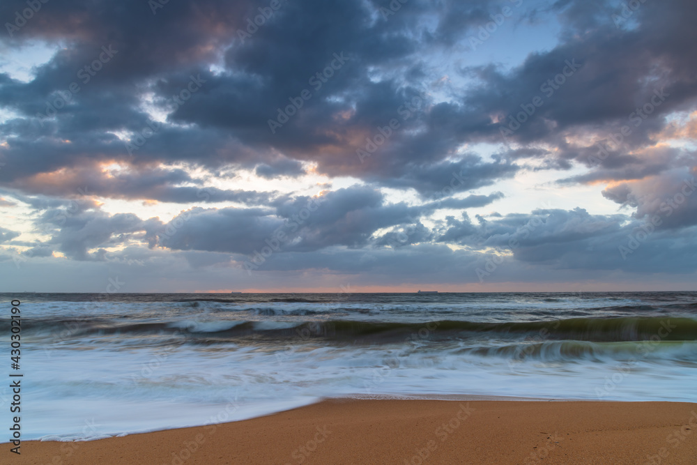 Sunrise at the seaside with a cloudy sky