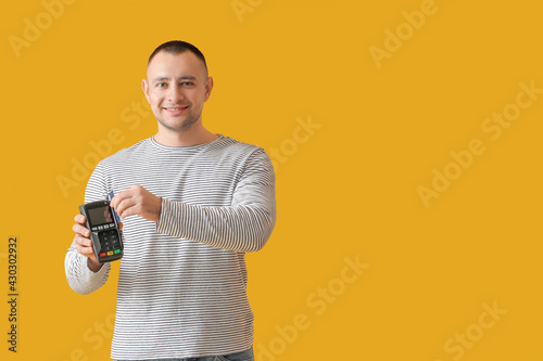 Man with payment terminal o...