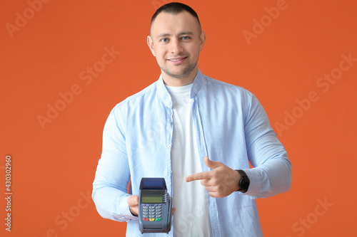Man with payment terminal o...