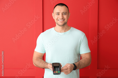 Man with payment terminal o...