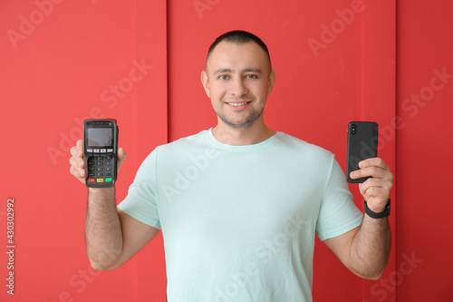 Man with payment terminal a...