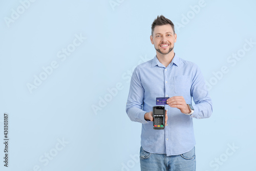 Smiling man holding a credi...