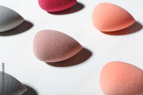 Different makeup sponges on white background, closeup
