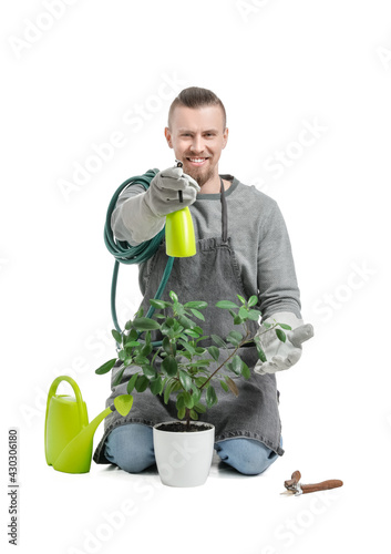 Young male gardener on whit...
