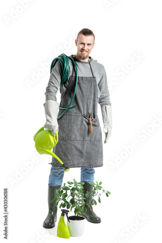 Young male gardener on whit...