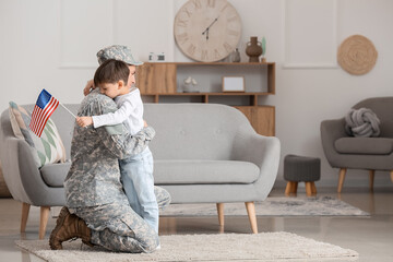 Soldier and his little son hugging at home. Memorial Day celebration