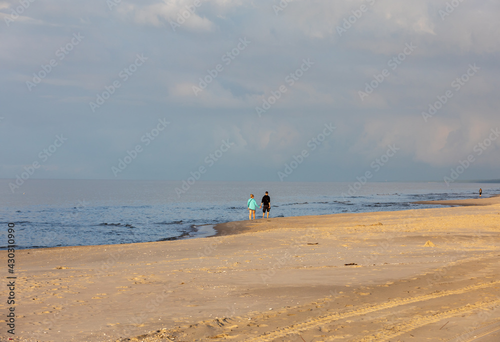 Romantic walk of a couple in love on the beach in Stegna, Pomerania. Poland
