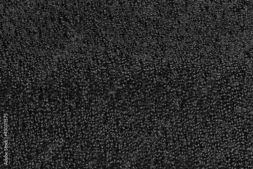 Black foam plastic background texture. black background for designers. dark styrofoam