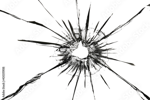 The effect of cracks on broken glass from a shot of a weapon. A hole in the glass of the bullet