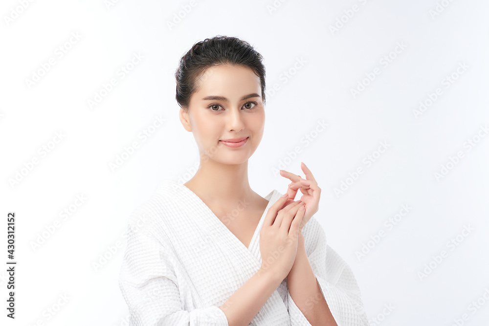 Beautiful young Asian woman wearing bathrobe on white background, Face care, Facial treatment, Cosmetology, beauty and spa Concept. Beautiful young Asian woman wearing bathrobe on white background, Face care, Facial treatment, Cosmetology, beauty and spa Concept.