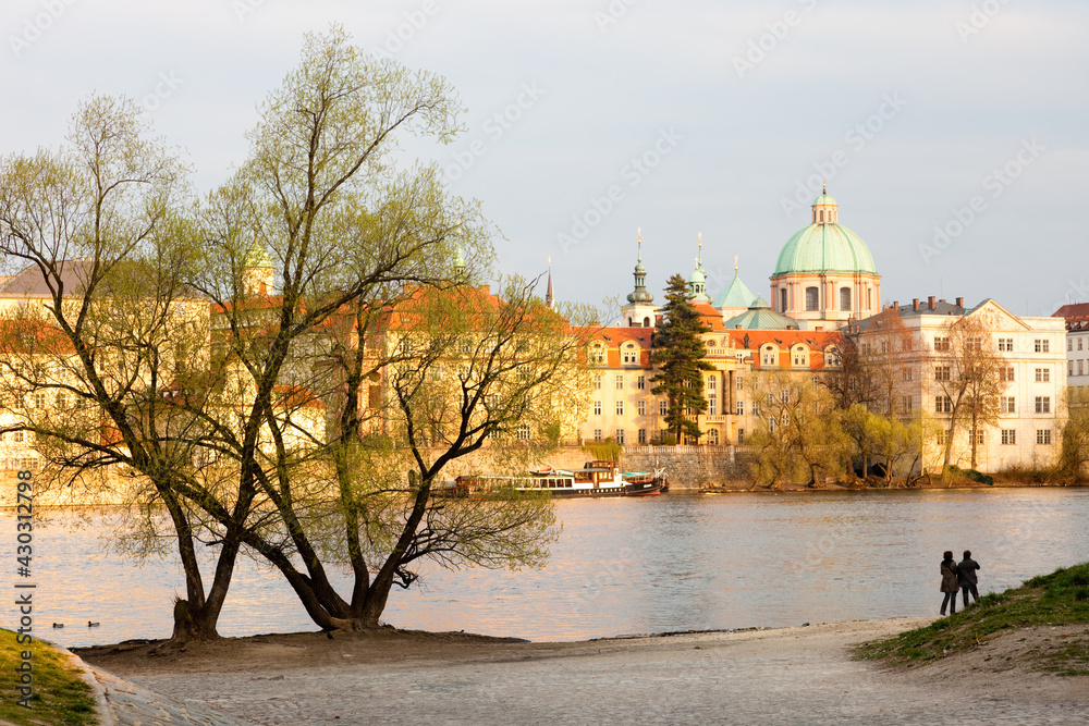 Riverbank Prague with Moldau River and couple enjoying city