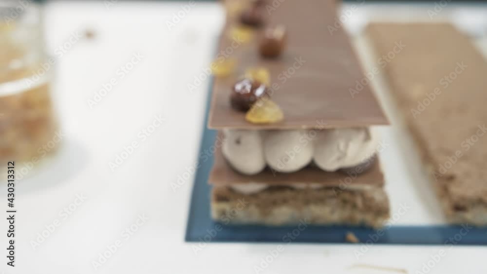 Chocolate bar or cake decorated with hazelnuts served on a buffet. Revealing close up shot Chocolate bar or cake decorated with hazelnuts served on a buffet. Revealing close up shot