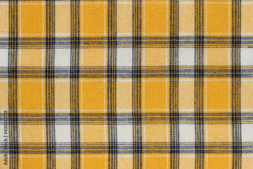 Yellow white tartan texture background. shirt fabric with a checkered pattern. factory material Yellow white tartan texture background. shirt fabric with a checkered pattern. factory material