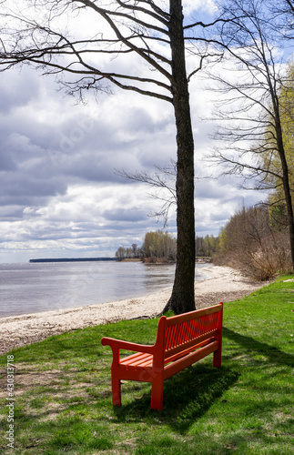 Empty bench in the spring park. The perfect place to get away from urban problems. © Stanislav