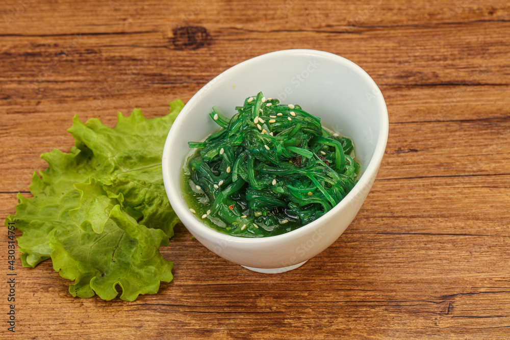 Green Chuka Seaweed Salad Isolated on White Background Top View. Wakame Sea Kelp Salat Green Chuka Seaweed Salad Isolated on White Background Top View. Wakame Sea Kelp Salat