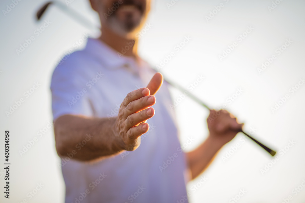Senior golfer spreading his hand. Close up. Focus is on hand. Senior golfer spreading his hand. Close up. Focus is on hand.