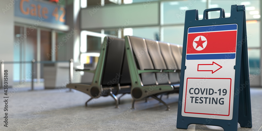 Fototapeta premium COVID-19 testing text and flag of North Korea on a sandwich board sign in the airport terminal, 3D rendering
