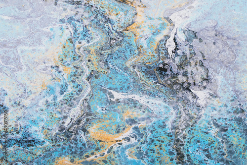 Liquid marble, fluid art, blue and gray ink background with paint spots. Swirl pattern, stained texture. Modern painting, creative colored wallpaper, water flow effect. Drawing motion waves. Tie dye. © tatyana