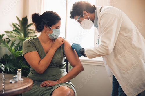 Woman getting covid-19 vaccination at home photo