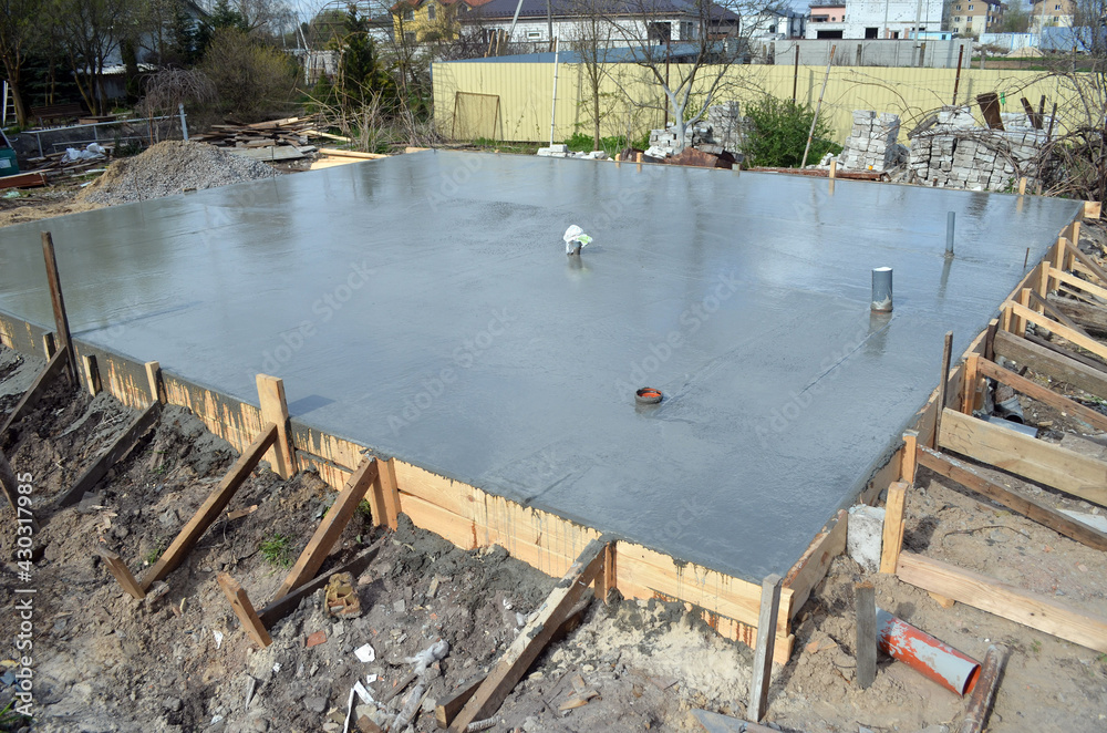 Timber formwork with metal reinforcement for pouring concrete and creating a solid foundation for a building or fence. Construction process. Timber formwork with metal reinforcement for pouring concrete and creating a solid foundation for a building or fence. Construction process.