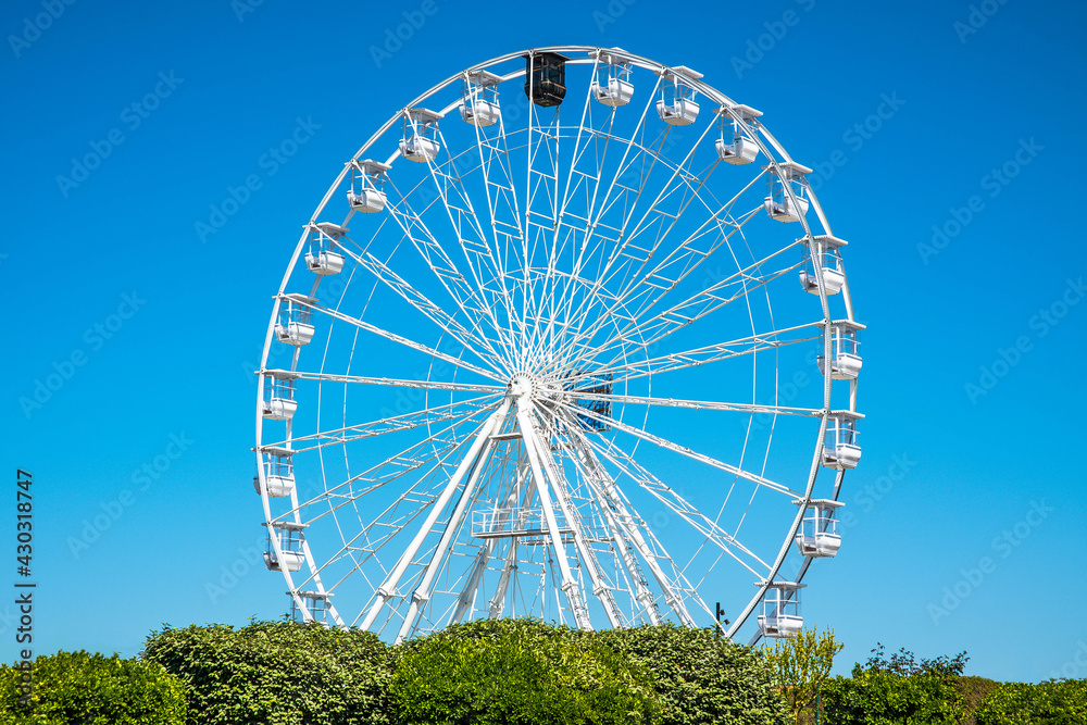 white ferris wheel in a blue sky white ferris wheel in a blue sky